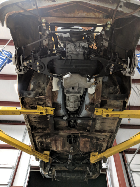 A view underneath the car, showing the new transmission and engine in place.